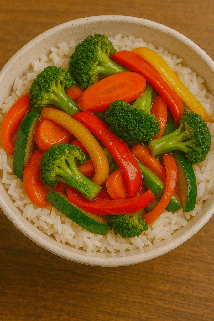 Colorful vegetable stir-fry with broccoli, bell peppers, and carrots served over white rice.