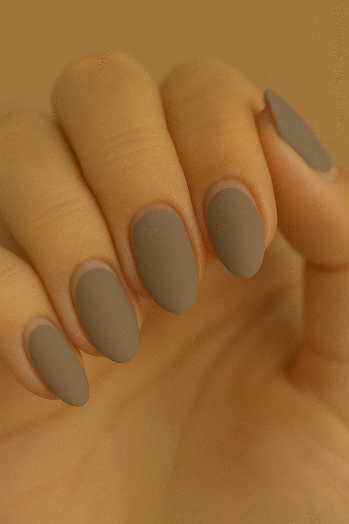 ALT: Cool taupe matte nails with curved negative-space arcs—minimalist office nail inspo USA.